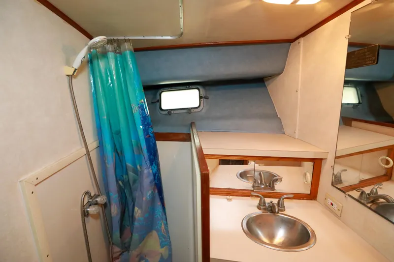 Slide: The Image of Interior cabin of 1991 Silverton 41 Aft Cabin with window and patterned bedding. - 36