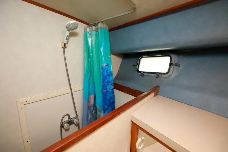 Slide: The Image of 1991 Silverton 41 Aft Cabin bathroom with shower, sink, and mirror. - 37