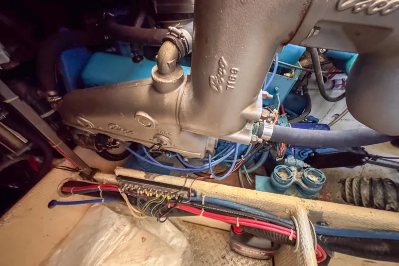 Slide: The Image of 1991 Silverton 41 Aft Cabin bathroom with shower, porthole, and colorful curtain. - 38