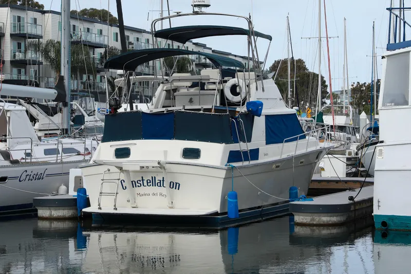 Slide: The Image of 1991 Silverton 41 Aft Cabin yacht docked at marina, surrounded by other boats. - 4