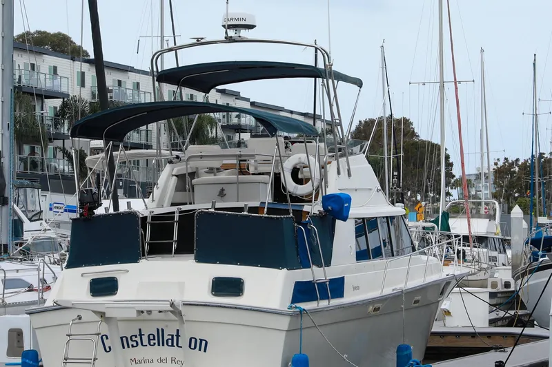 Slide: The Image of 1991 Silverton 41 Aft Cabin yacht docked at Marina del Rey, surrounded by other boats. - 6