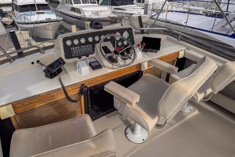 Slide: The Image of Cockpit of 1991 Silverton 41 Aft Cabin yacht with steering wheel and navigation equipment. - 8