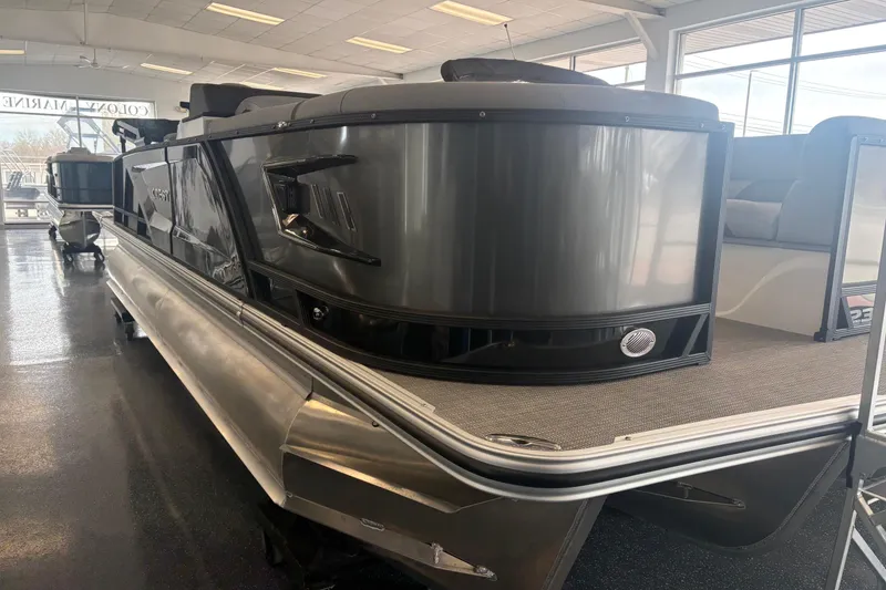 The Image of 2026 Crest 230 SLRC Caribbean pontoon boat in showroom, sleek design, modern features. - 1