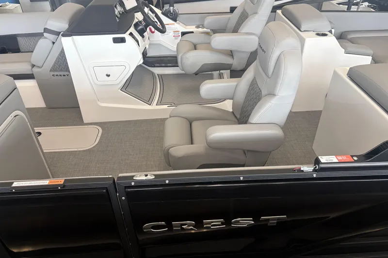 Slide: The Image of Interior of 2026 Crest 230 SLRC Caribbean boat with luxurious seating and modern dashboard. - 6