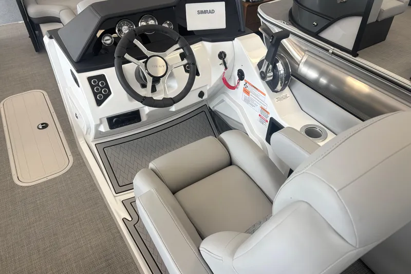 Slide: The Image of Interior of 2026 Crest 230 SLRC Caribbean boat with steering wheel and controls. - 8