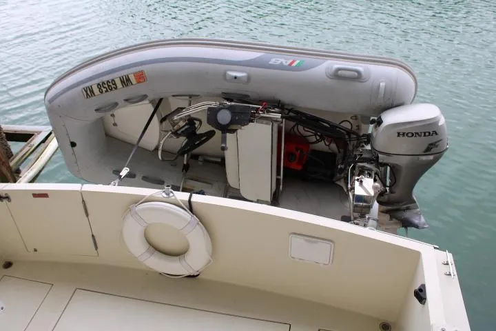 Slide: The Image of 1988 Tollycraft 30 Sport Cruiser with inflatable dinghy and Honda outboard motor. - 10