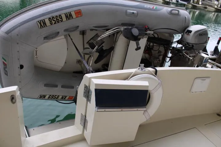 Slide: The Image of 1988 Tollycraft 30 Sport Cruiser with inflatable dinghy and Honda outboard motor. - 13