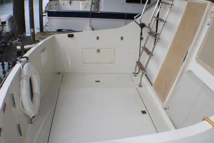 Slide: The Image of 1988 Tollycraft 30 Sport Cruiser deck with ladder and life preserver. - 14