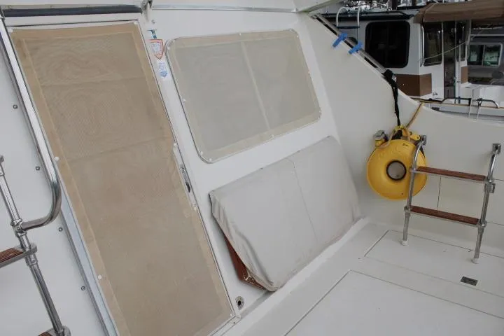 Slide: The Image of 1988 Tollycraft 30 Sport Cruiser deck with safety equipment and seating area. - 15