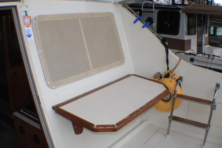 Slide: The Image of 1988 Tollycraft 30 Sport Cruiser interior with foldable table and ladder. - 16
