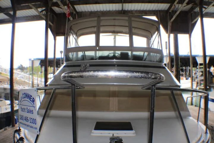 Slide: The Image of 1988 Tollycraft 30 Sport Cruiser docked under a covered marina. - 2