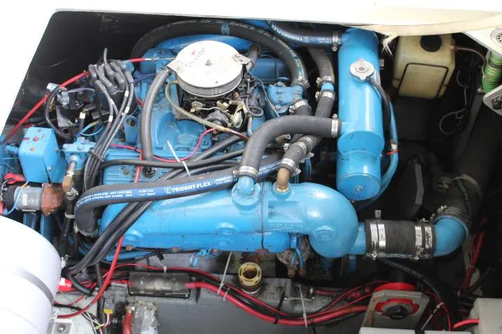 Slide: The Image of Engine compartment of a 1988 Tollycraft 30 Sport Cruiser with blue components and wiring. - 21