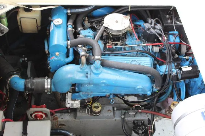 Slide: The Image of Engine compartment of a 1988 Tollycraft 30 Sport Cruiser, featuring a blue marine engine. - 22