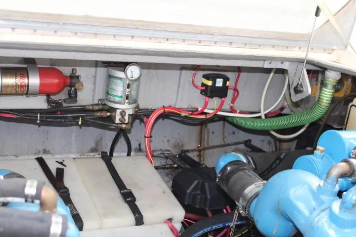 Slide: The Image of Engine compartment of 1988 Tollycraft 30 Sport Cruiser with visible wiring and components. - 23