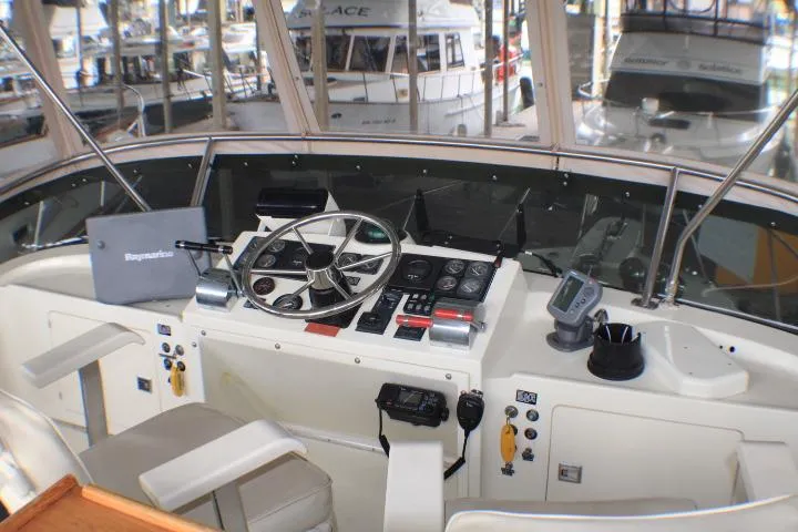 Slide: The Image of Cockpit of 1988 Tollycraft 30 Sport Cruiser with steering wheel and navigation instruments. - 28