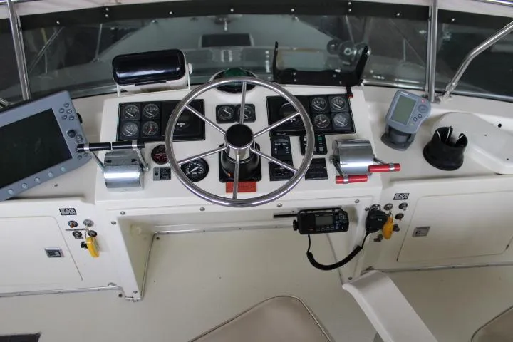 Slide: The Image of 1988 Tollycraft 30 Sport Cruiser helm with steering wheel and navigation instruments. - 29