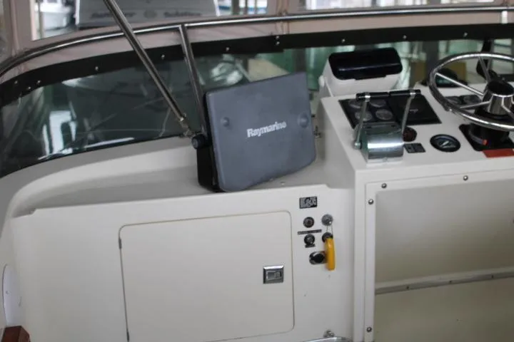 Slide: The Image of 1988 Tollycraft 30 Sport Cruiser helm with Raymarine navigation system. - 32
