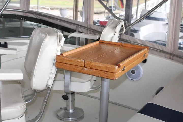 Slide: The Image of Interior of 1988 Tollycraft 30 Sport Cruiser with wooden table and white seating. - 39