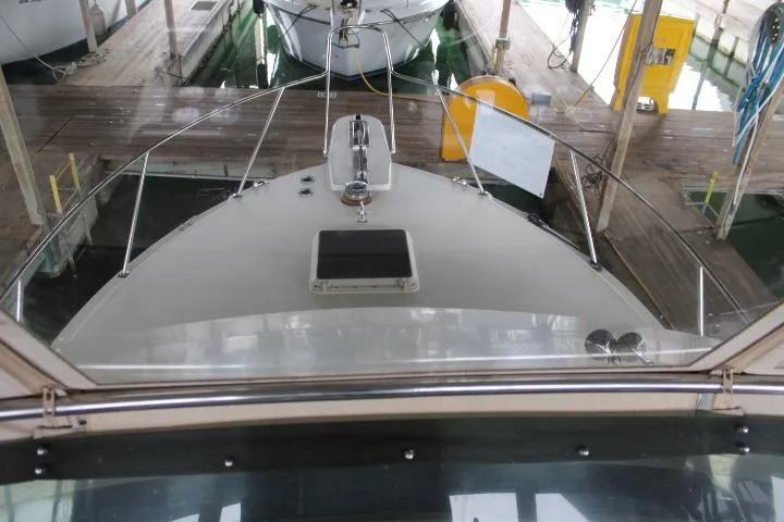 Slide: The Image of 1988 Tollycraft 30 Sport Cruiser docked in a marina, viewed from the bow. - 4