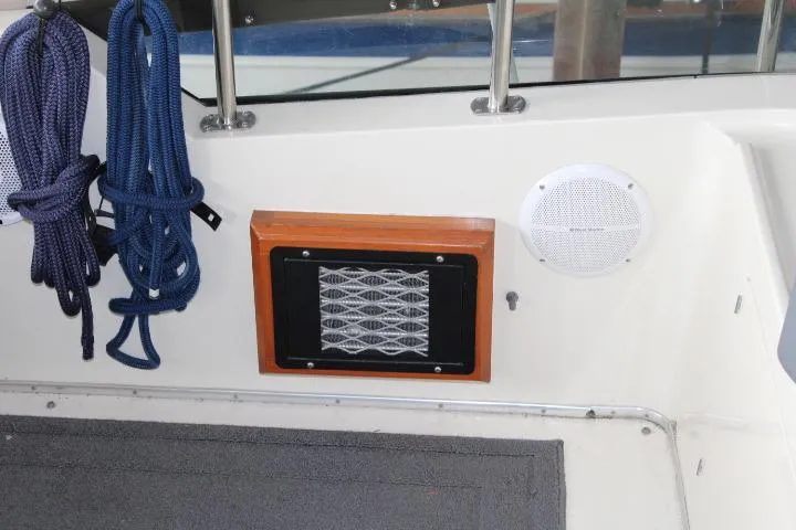 Slide: The Image of 1988 Tollycraft 30 Sport Cruiser interior with speaker, vent, and coiled ropes. - 40