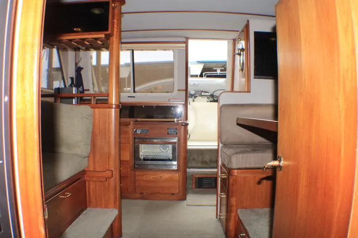 Slide: The Image of Interior of 1988 Tollycraft 30 Sport Cruiser with wood finishes and seating area. - 41