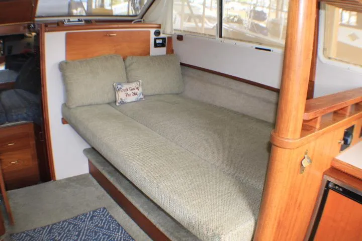 Slide: The Image of 1988 Tollycraft 30 Sport Cruiser interior with cozy seating and wooden accents. - 46