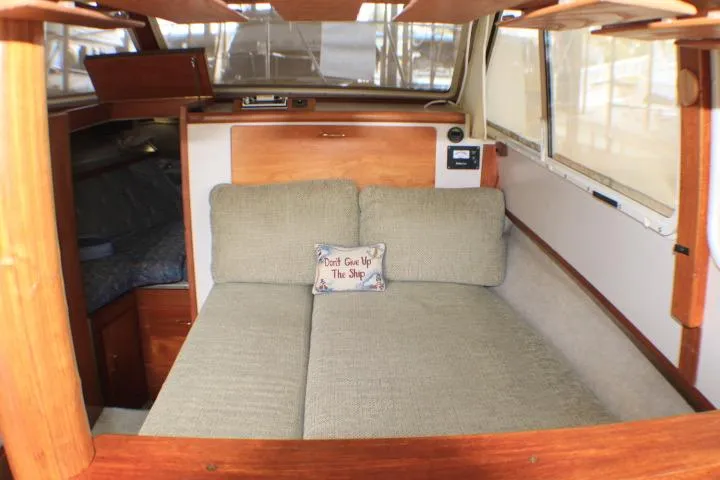 Slide: The Image of Interior of 1988 Tollycraft 30 Sport Cruiser with cozy seating and nautical decor. - 47
