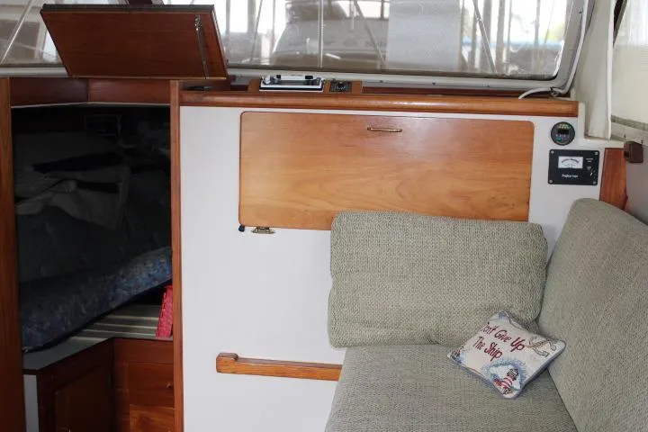 Slide: The Image of Interior of 1988 Tollycraft 30 Sport Cruiser with cozy seating and nautical decor. - 48