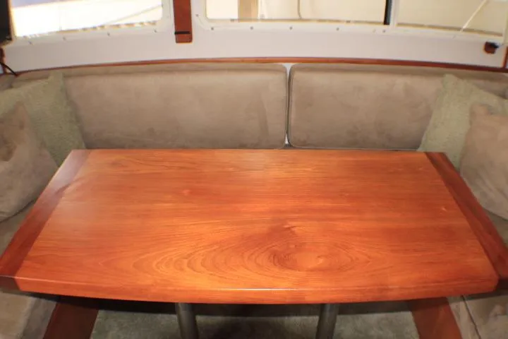 Slide: The Image of Interior of 1988 Tollycraft 30 Sport Cruiser with wooden table and cushioned seating. - 53