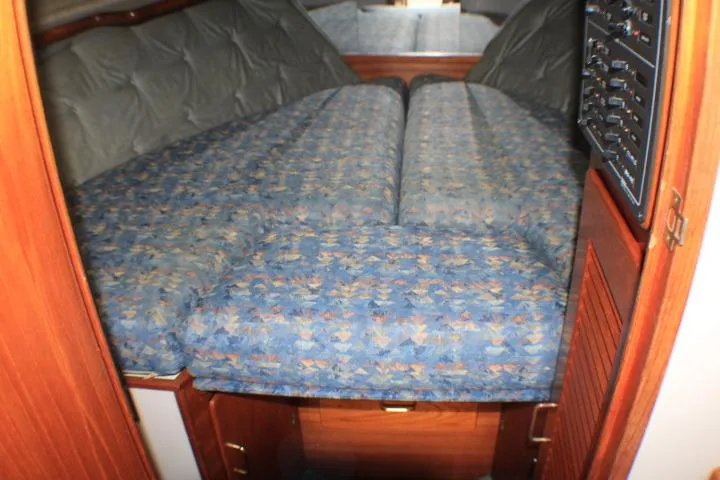 Slide: The Image of 1988 Tollycraft 30 Sport Cruiser cabin with blue patterned bedding. - 67