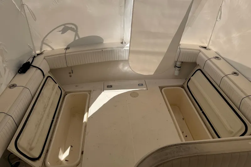Slide: The Image of 2006 Carolina Classic 28 boat interior with open storage compartments. - 10