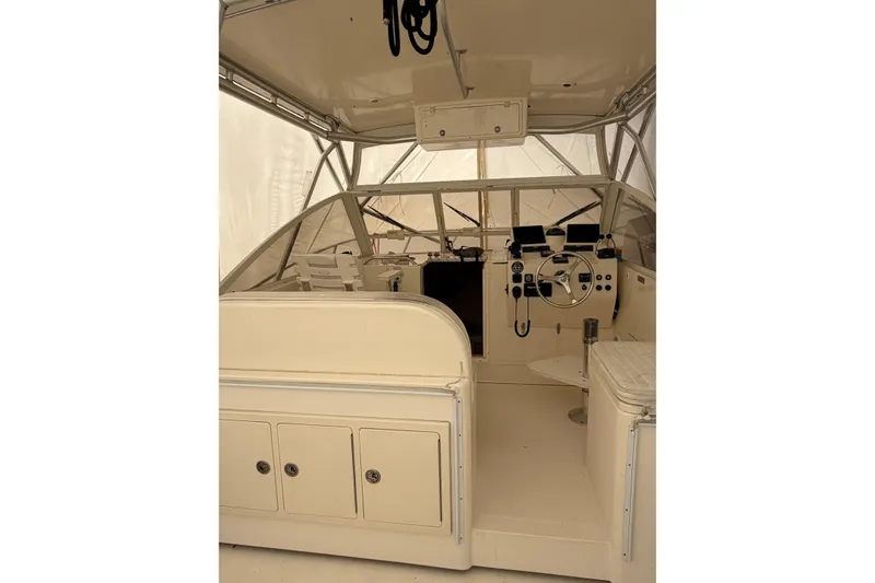 Slide: The Image of 2006 Carolina Classic 28 boat interior with helm, steering wheel, and control panels. - 12