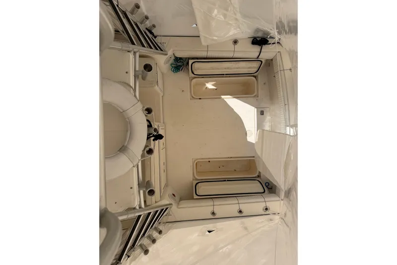 Slide: The Image of Interior view of a 2006 Carolina Classic 28 boat, showcasing seating and storage areas. - 15