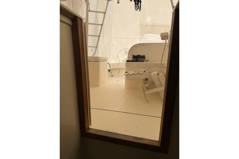 Slide: The Image of Interior view of a 2006 Carolina Classic 28 boat, featuring seating and ladder. - 3