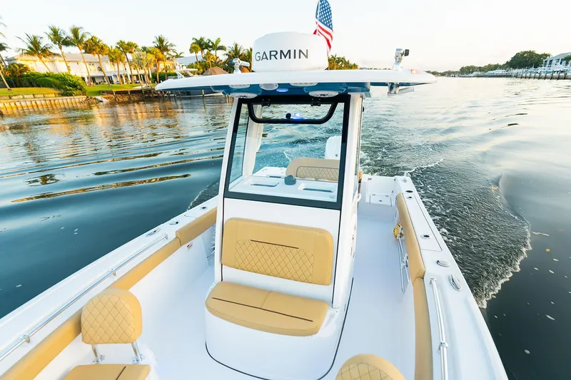 Slide: The Image of Manufacturer Provided Image: 2025 Sportsman Open 212 Center Console boat cruising on a scenic waterway. - 5