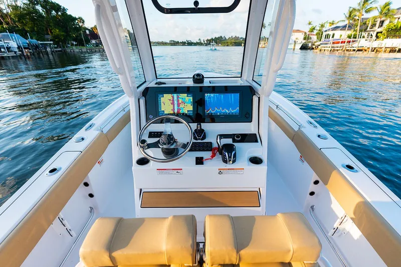 Slide: The Image of Manufacturer Provided Image: 2025 Sportsman Open 212 Center Console boat interior with navigation screens on a sunny day. - 6