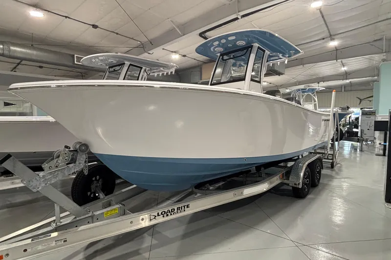 The Image of 2025 Sportsman Open 232 Center Console boat on trailer in showroom. - 12