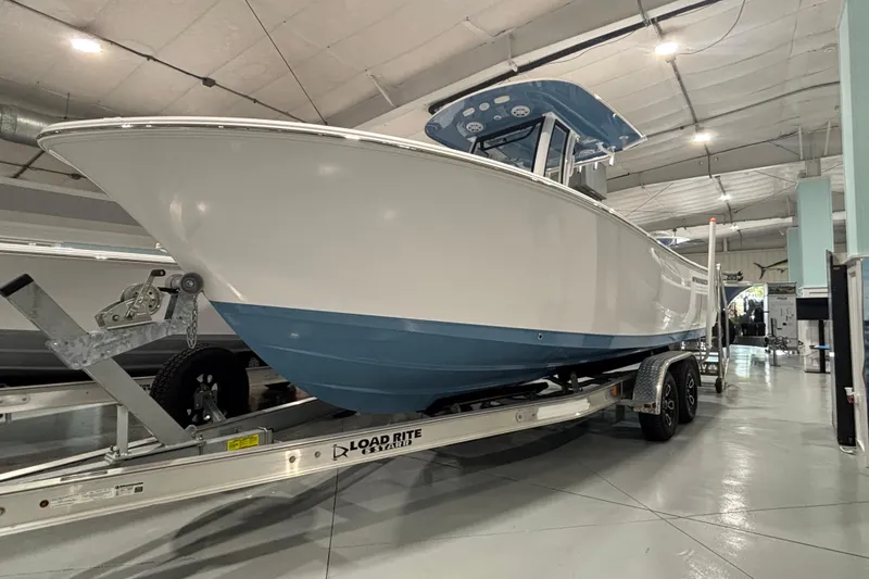 Slide: The Image of 2025 Sportsman Open 232 Center Console boat on trailer in showroom. - 14