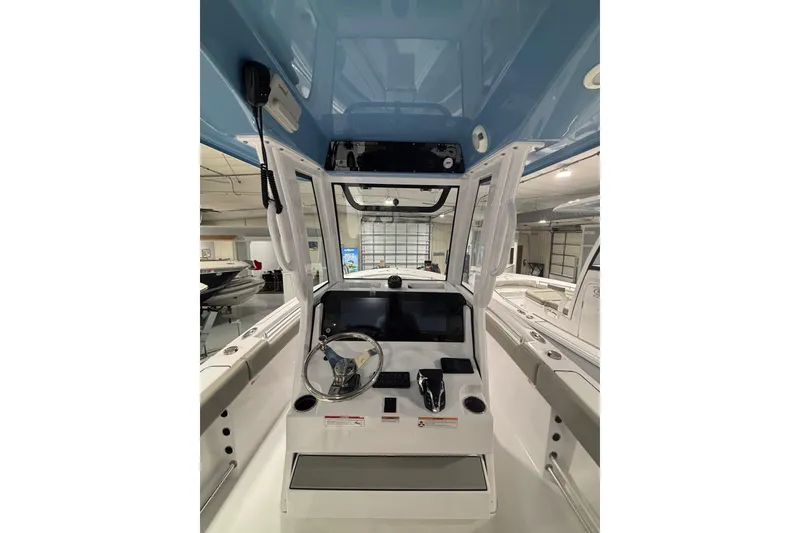Slide: The Image of 2025 Sportsman Open 232 Center Console boat interior with steering wheel and control panel. - 16