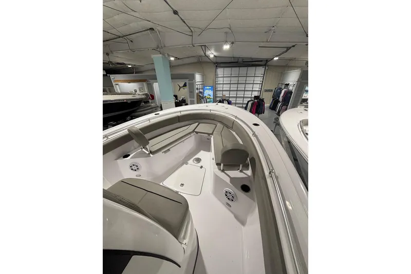 Slide: The Image of 2025 Sportsman Open 232 Center Console boat interior with seating and storage. - 18