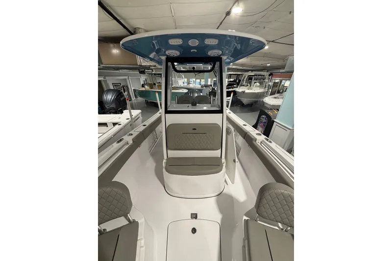 Slide: The Image of 2025 Sportsman Open 232 Center Console boat interior with seating and helm station. - 19
