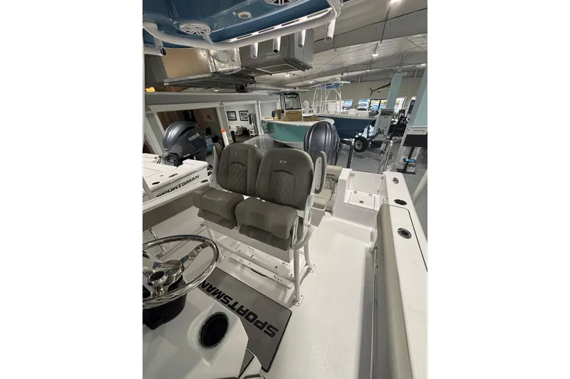 Slide: The Image of 2025 Sportsman Open 232 Center Console boat interior with dual seats and steering wheel. - 20