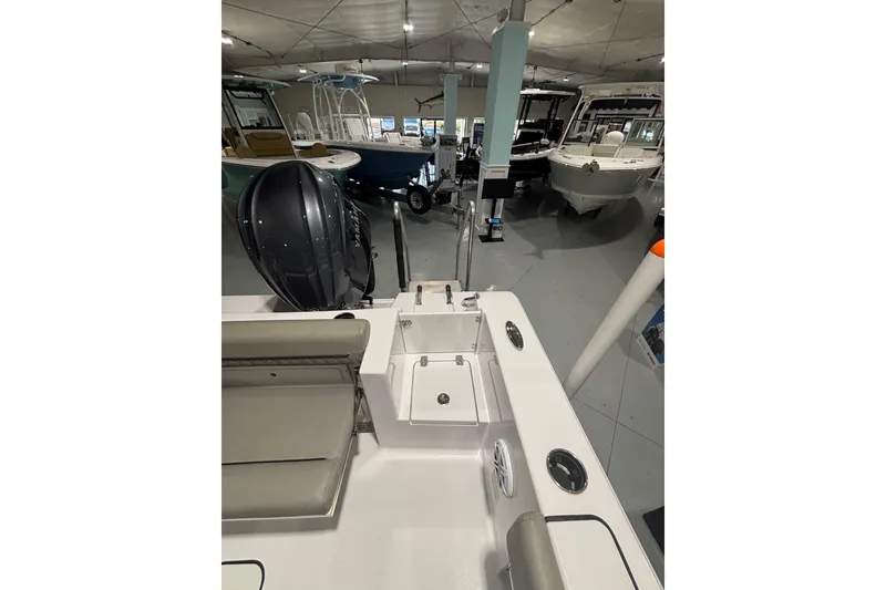 Slide: The Image of 2025 Sportsman Open 232 Center Console boat interior in showroom, featuring modern design and equipment. - 22
