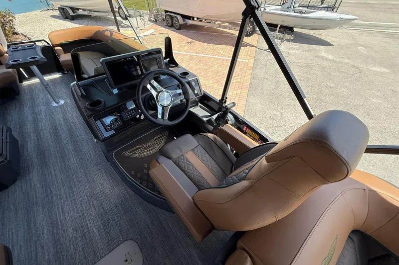 Slide: The Image of Interior of 2026 Bennington 24 M Quad Bench boat with modern helm and seating. - 10