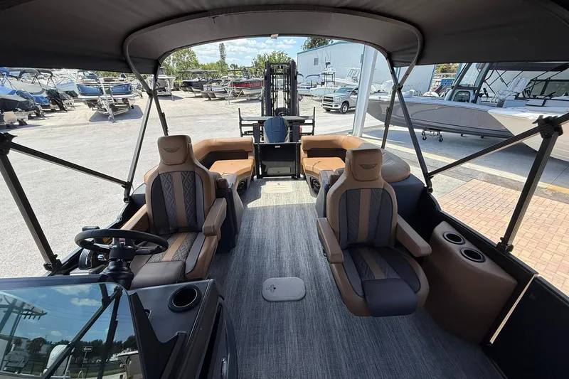 Slide: The Image of Interior of 2026 Bennington 24 M Quad Bench pontoon boat with luxurious seating and helm. - 12