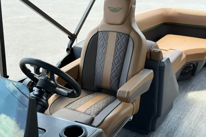 Slide: The Image of Luxurious interior of 2026 Bennington 24 M Quad Bench boat with elegant seating and steering wheel. - 13