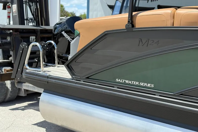 Slide: The Image of 2026 Bennington 24 M Quad Bench pontoon boat, Saltwater Series, with tan seating and Mercury engine. - 3