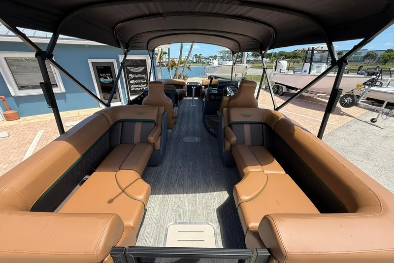 Slide: The Image of 2026 Bennington 24 M Quad Bench pontoon boat with spacious seating and canopy. - 6