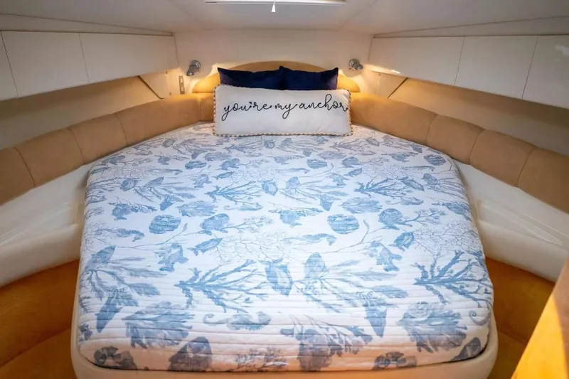 Slide: The Image of Cozy cabin interior of 1999 Cranchi Mediterranee 41 with floral bedding and decorative pillow. - 16