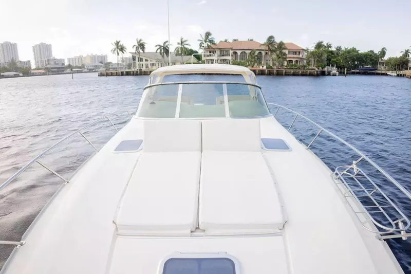 Slide: The Image of 1999 Cranchi Mediterranee 41 yacht on water, with luxurious deck and scenic waterfront view. - 5